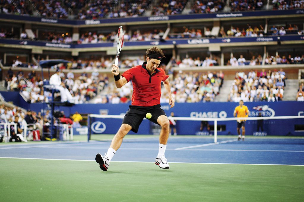 Federer demonstrates his legendary “tweener” shot against Novak Djokovic in the semi finals of the 2009 US Open (Image © Getty Images)