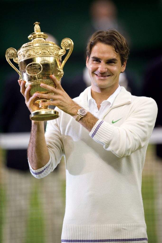 Federer lifts the Wimbledon trophy in 2012 (Image © AELTC Jon Buckle)