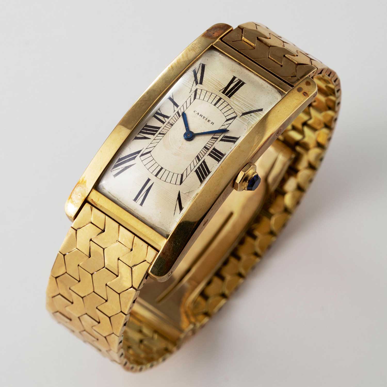 Yellow gold Tank Cintrée from the 1950s marks a significant Cartier design evolution with the octagonal flat crown and cabochon, from the old pointed crown (Image © Revolution)
