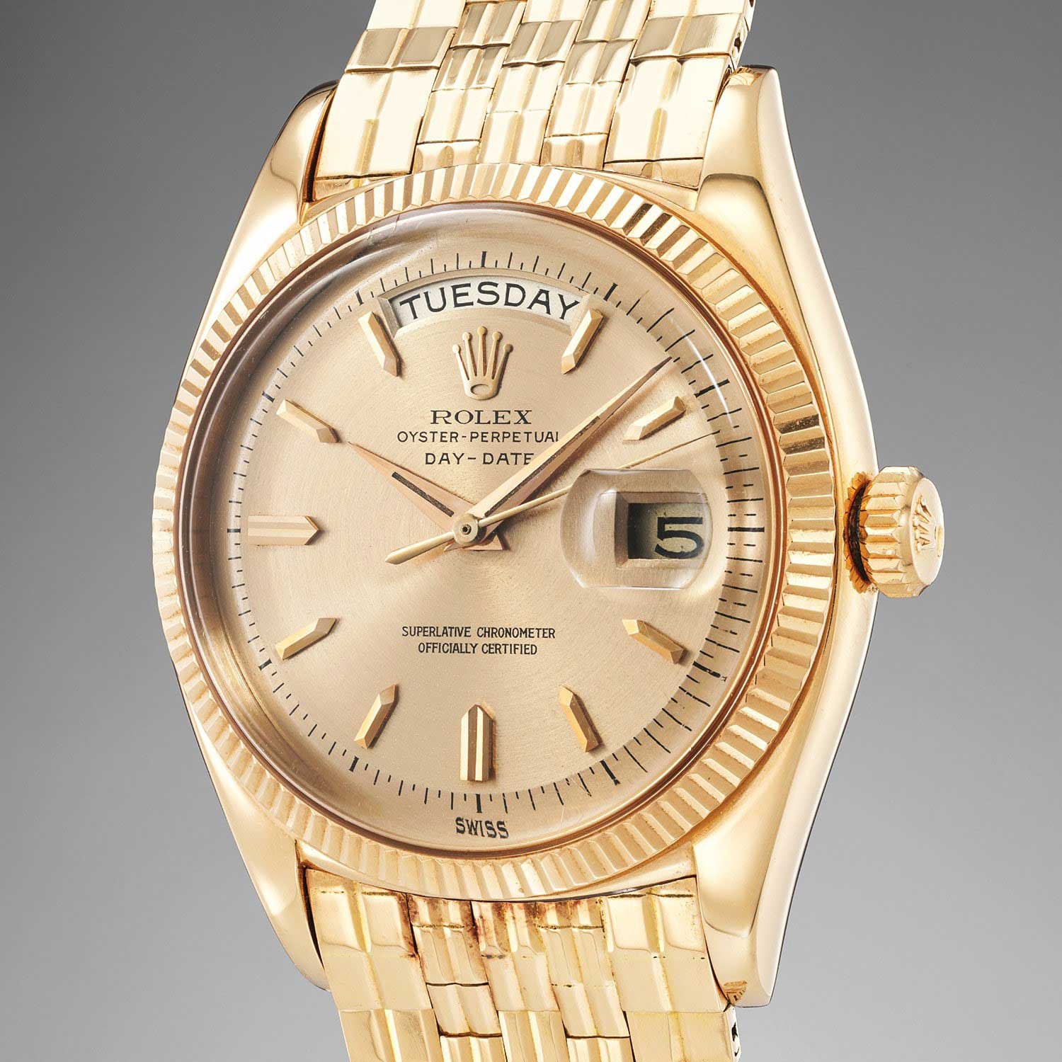 Lot 243: Rolex Ref. 1803. A very rare and impressive pink gold wristwatch with center seconds, day, date and brick link bracelet