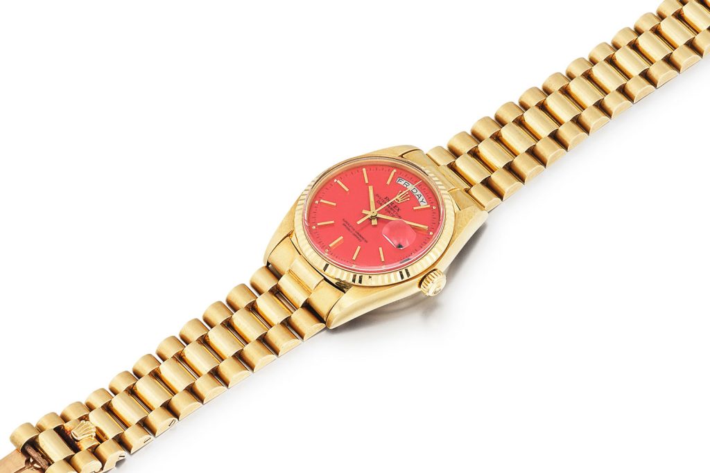 Lot 386: Rolex 'Stella' Day-Date Ref. 1803. Yellow gold wristwatch with day, date and red Stella dial, circa 1975