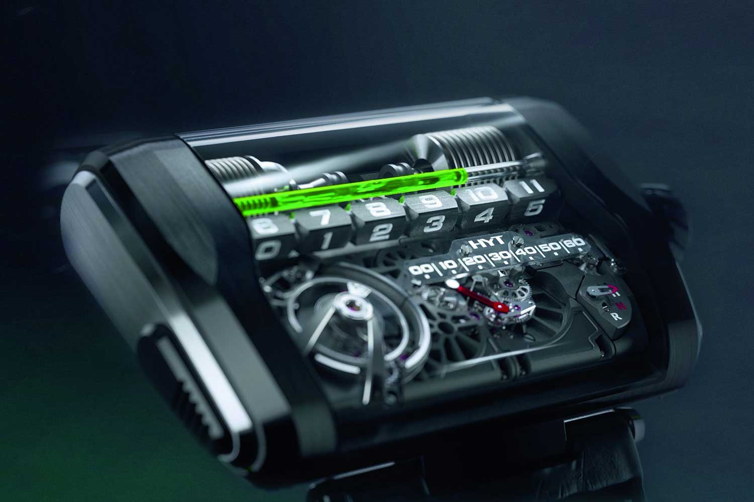 HYT’s H3 has a dual linear display for the hours and minutes, with a liquid tube that is combined with a jumping mechanism for a row of six hour markers which rotate to indicate the speicfic hour as the liquid goes back and forth on the display. A linear minutes display futher indicates the exact time.