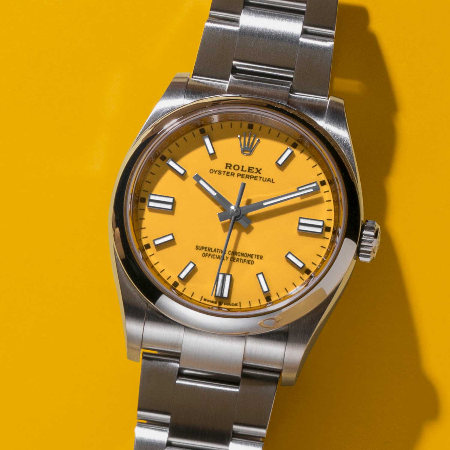 Rolex Oyster Perpetual 36 with a yellow dial and an Oyster bracelet.