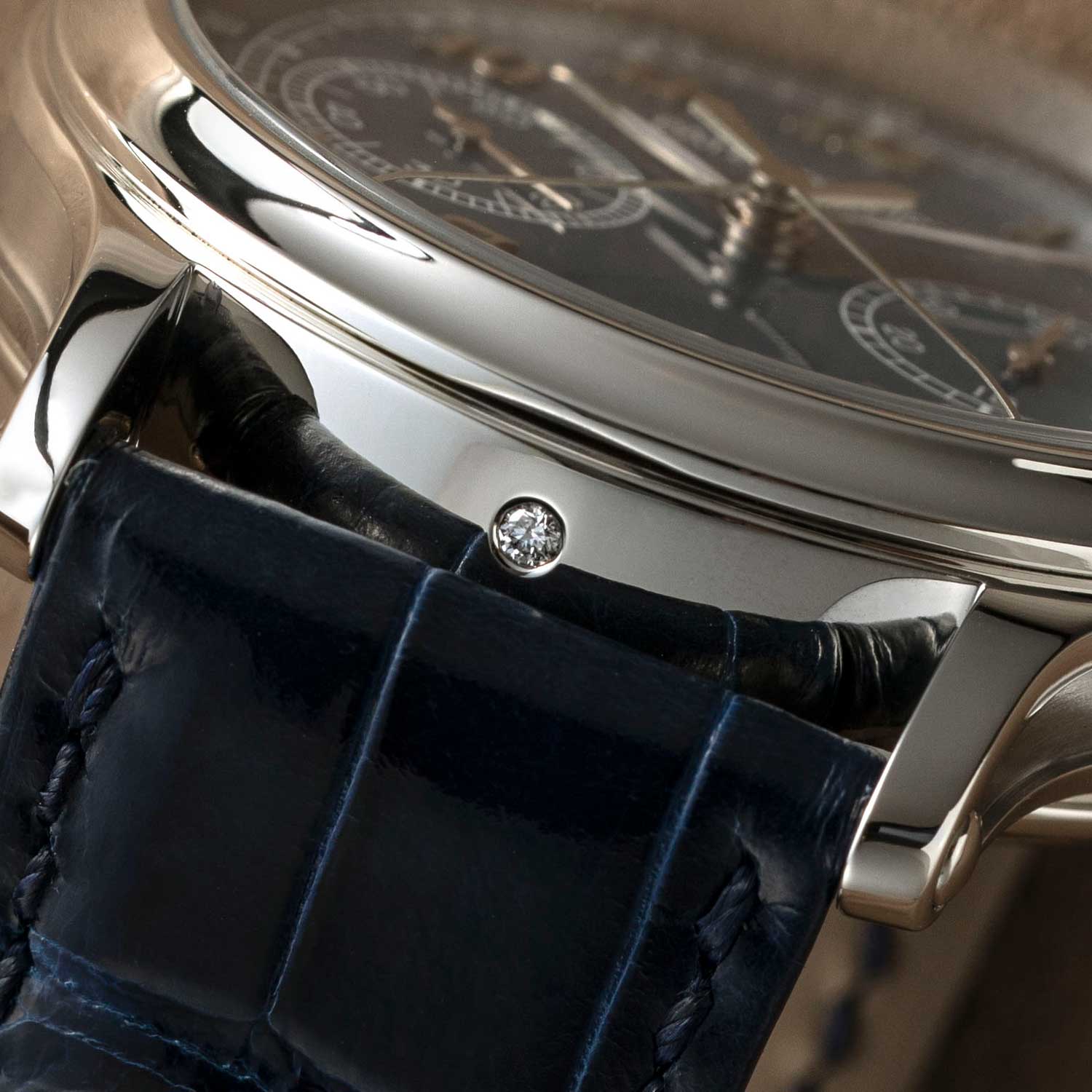It is Patek Philippe's convention to identify their platinum cases by placing a small diamond on the side of the case, just under the 6 o'clock hour marker; seen here on the case of the 5370P-011 (©Revolution)