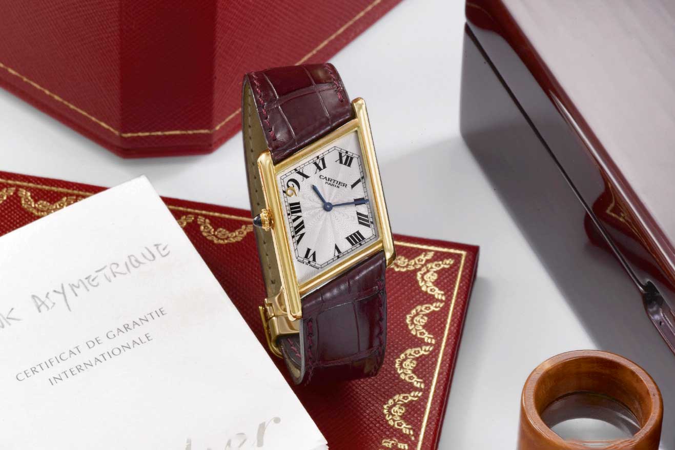 In 1999, Cartier created two sets of watches produced in left-handed and right-handed versions, each in a 99-piece limited run to commemorate the Macau Handover; the watch, in a smaller size (23mm by 32mm), had a Roman-numeral dial but with an applied 18K gold “9” above the Arabic-numeral “9” to form “99”; pictured here is the version of the watch with the crown on the left