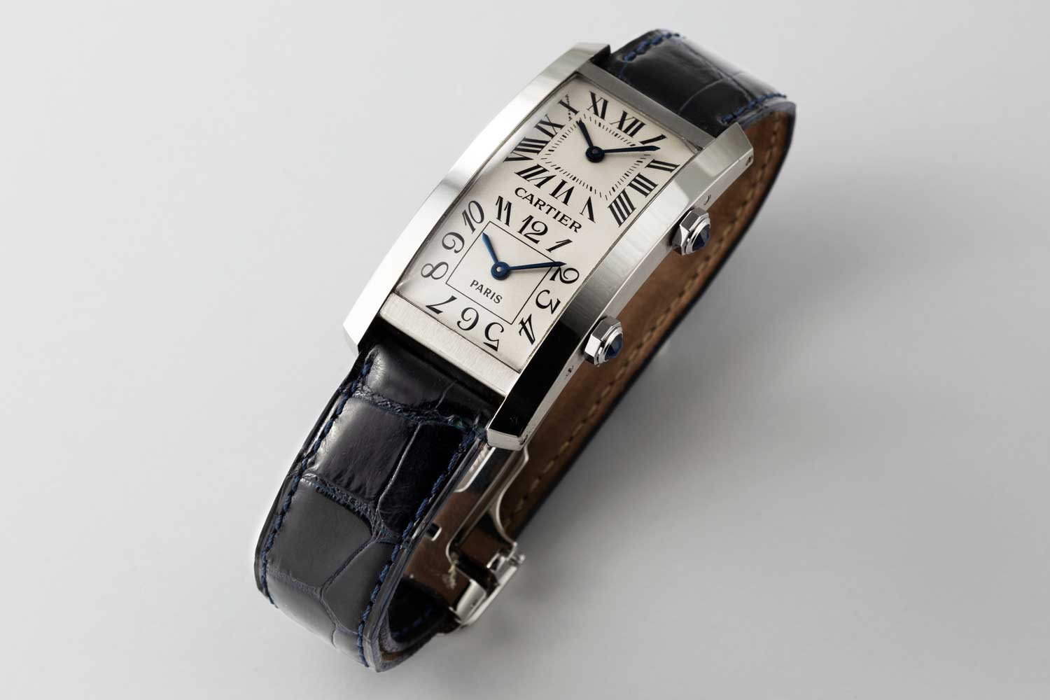 1996 No. 1/1 Cartier Paris Tank Cintrée in platinum with faceted sapphire-set winding-crown; double white gold dial with Roman chapters for home time and Arabic numerals for local time, blued steel "glaive" hands; two rhodium plated 6 3/4"' two movements, Cartier Caliber 067; this particular example is from the private collection of Auro Montanari (©Revolution)