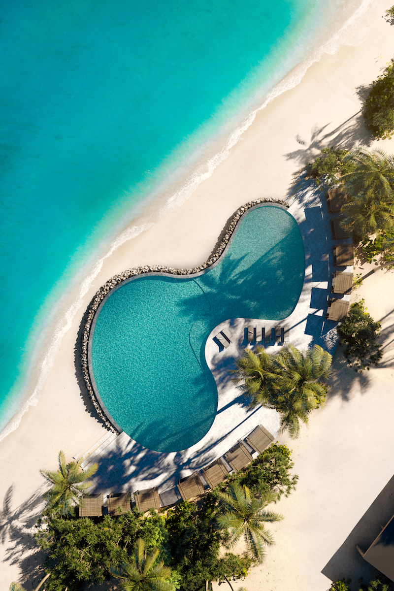 An aerial view of the beach club and pool at Patina Maldives