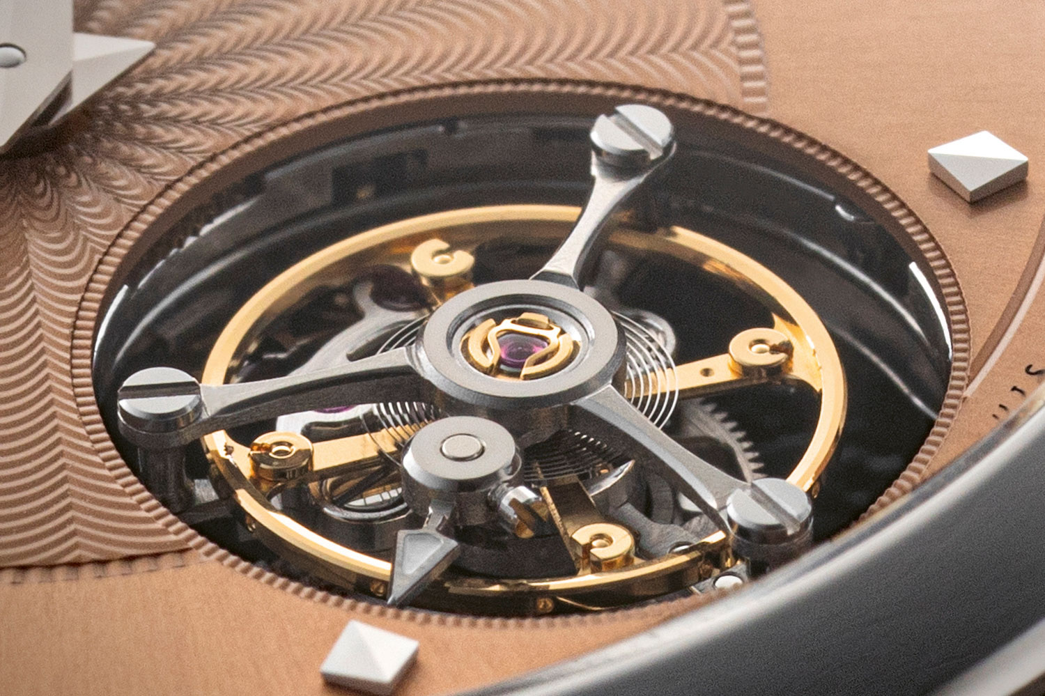 White triangle-shaped small seconds hand affixed to the flying tourbillon carriage crucial for COSC certification; notice also the 60 notches around the rim of tourbillon aperture serving as a seconds scale (©Revolution)