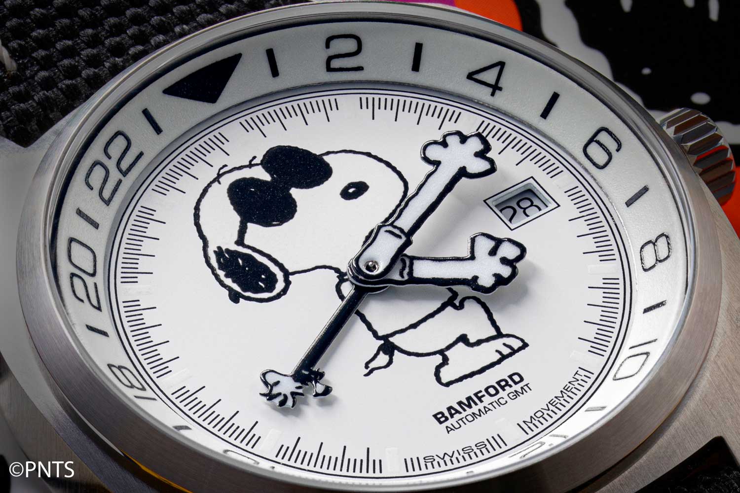 The dial features a prominent image of Snoopy, whose four-toed paws form the hour and minute hands for the main time display. (©Revolution)