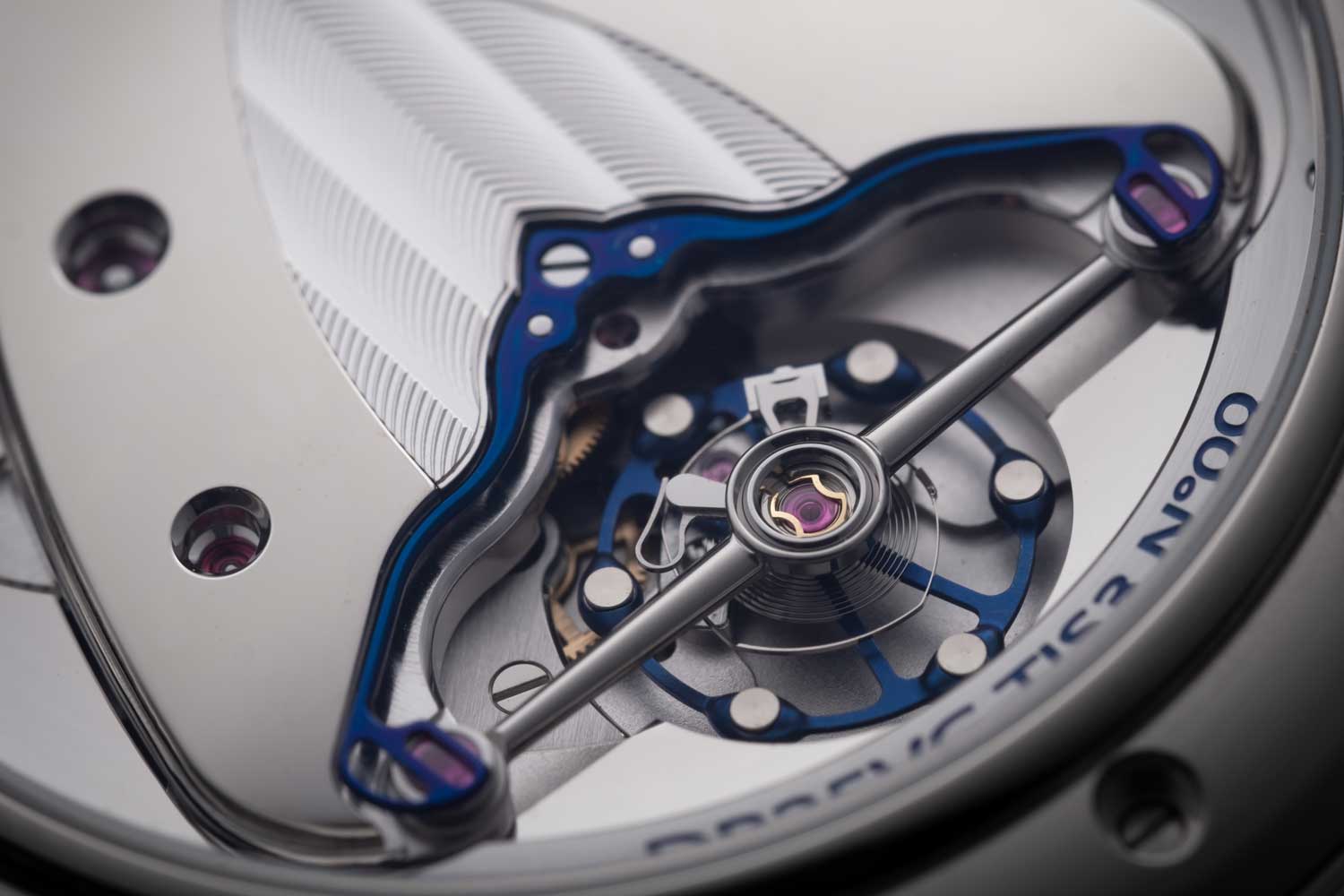 The reverse side of the movement reveals the latest titanium balance with white gold inlays