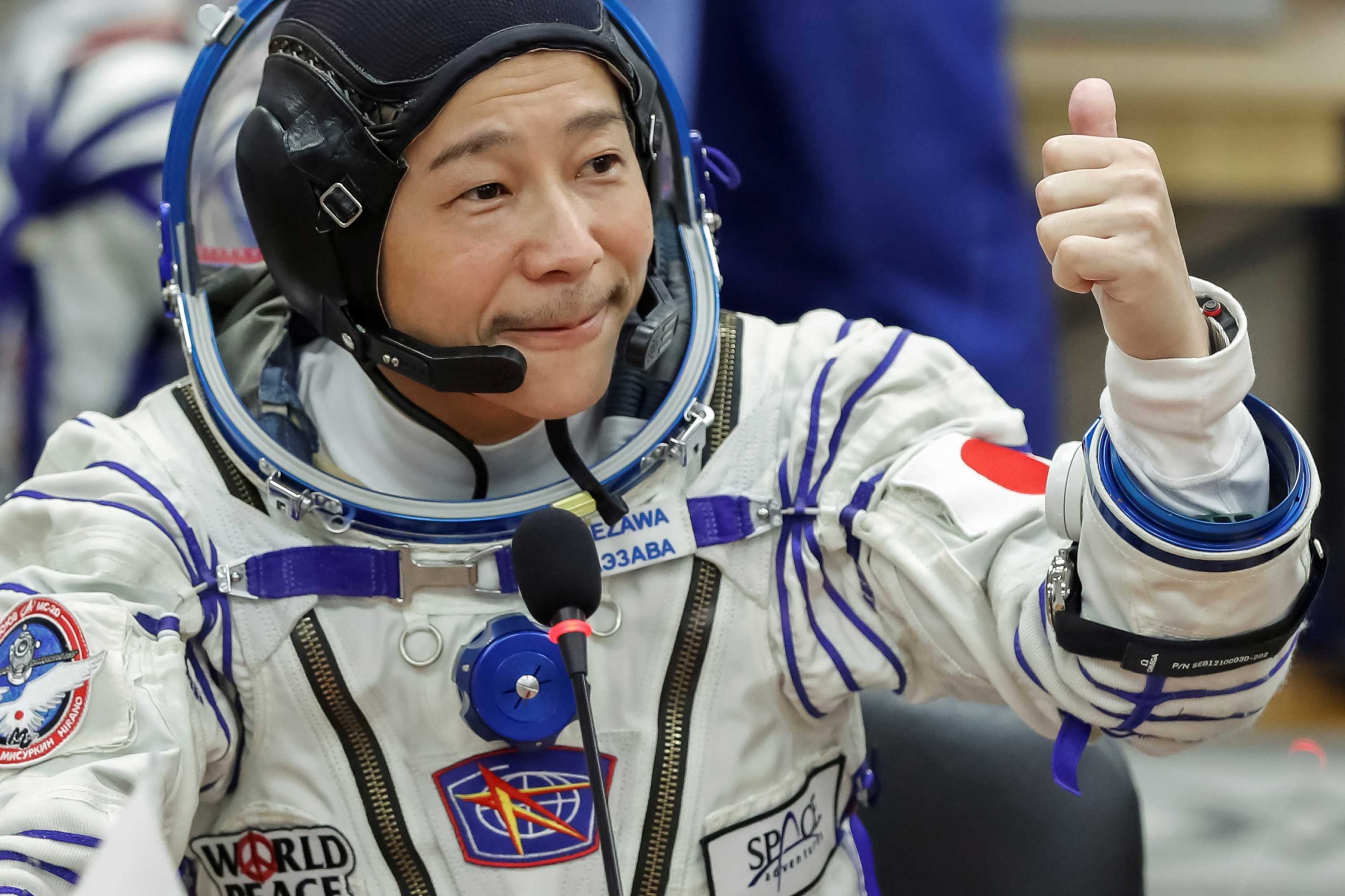 Japanese entrepreneur Yusaku Maezawa shortly before the launch to the International Space Station (ISS) at the Baikonur Cosmodrome, Kazakhstan, December 8, 2021. Clearly visible here strapped to his left arm over his suit, the Speedmaster on a velcro strap. And! Peeking from under his left cuff the UNMISTAKABLE silhouette of Richard Mille's tonneau case