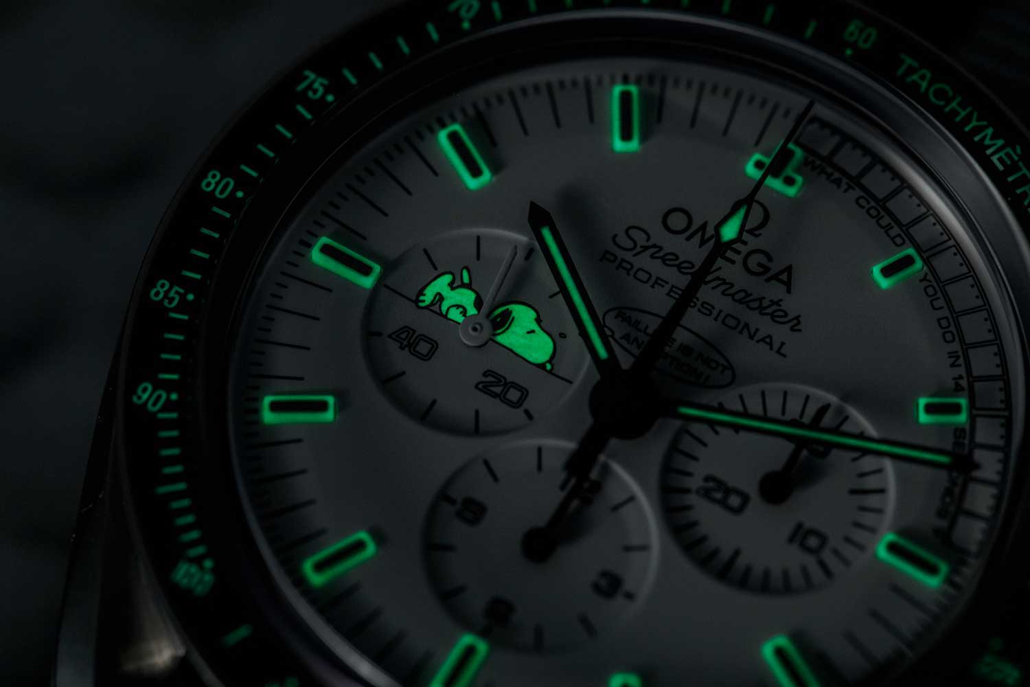 The Silver Snoopy Speedmaster's dial and bezel glowing in the dark (Image © Revolution)