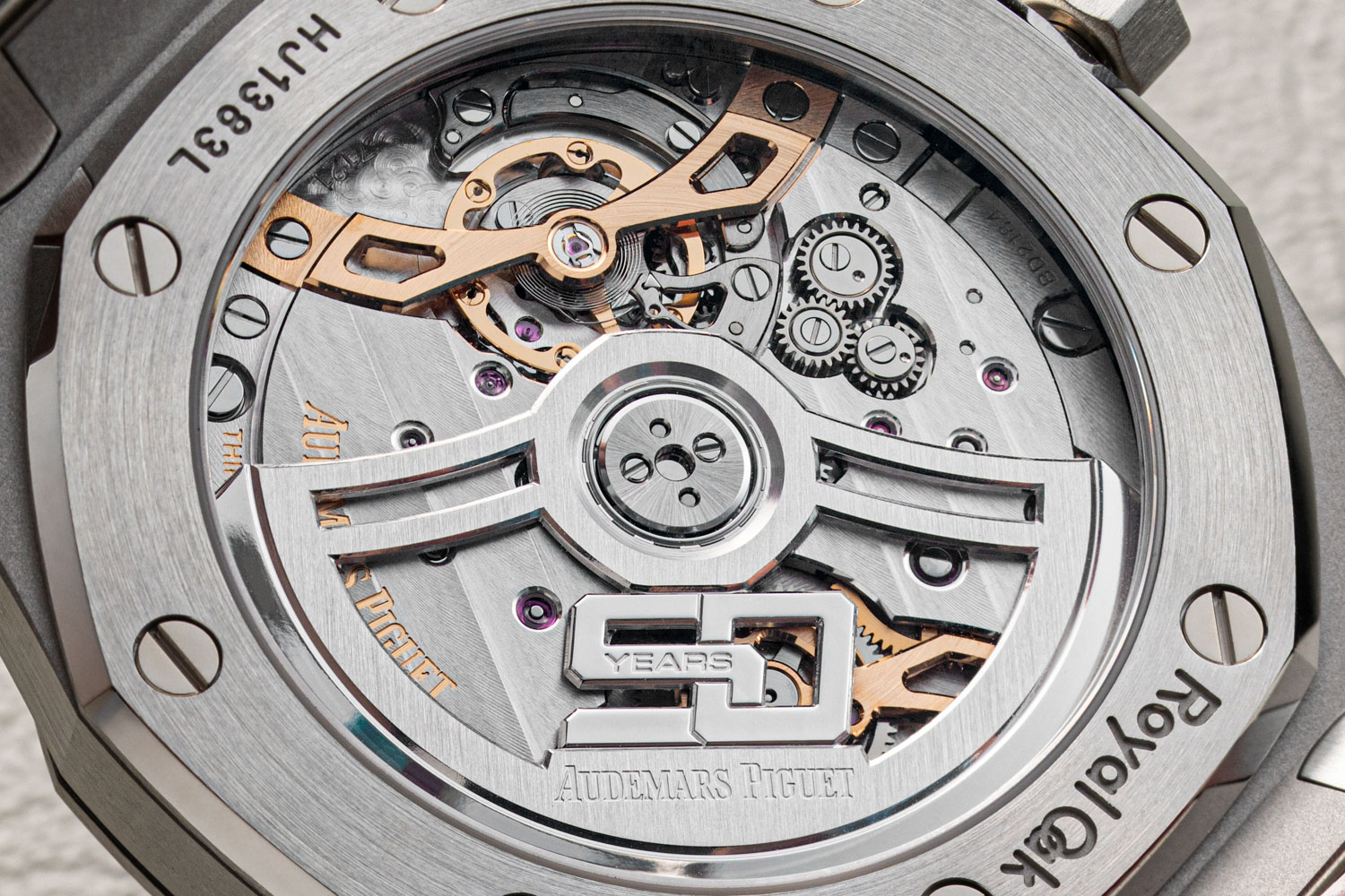 The all new Calibre 7121 visible through the caseback showing off its traversing balance bridge and special 50th anniversary rotor (©Revolution)