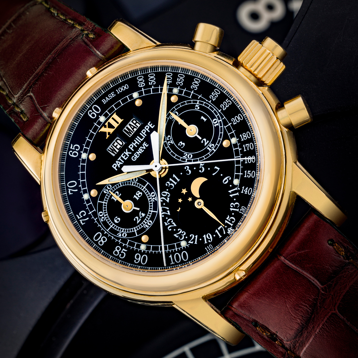 Lot 2520: Patek Phliippe 18k Gold Manual Winding Split Seconds Chronograph Wristwatch with Moon Phases, 24 Hour, Leap Year Indication And Black Monogram Dial With Luminous Hour Markers And Tachymeter Scale, Circa 2011