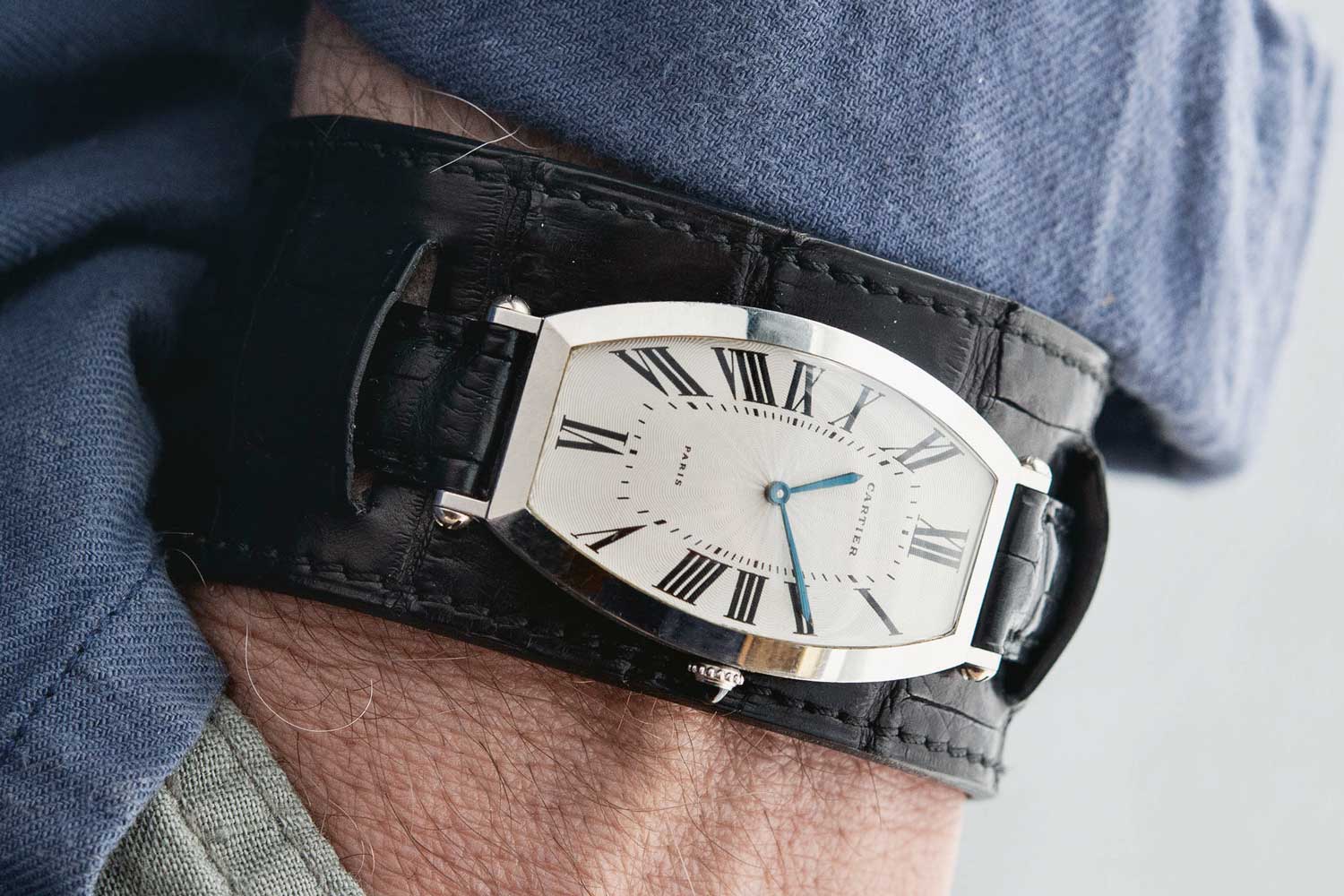 Bulang style for watch lovers — watches and accessories such as this platinum Cartier Tonneau on black leather cuff strap (Image: Bulang and Sons)