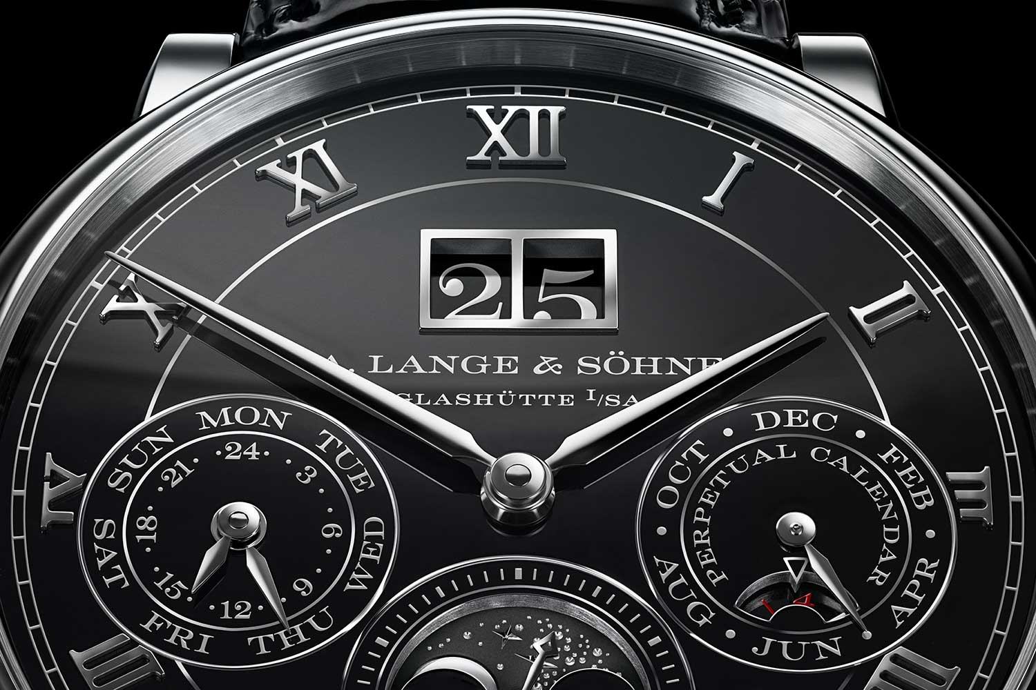 Made of white gold and filled with black enamel, the four-part dial displays the outsize date and accompanying subsidiary dials — day-of-the-week, 24-hour indicator, month and leap year indicators, small seconds and moon phases — against a glossy black surface