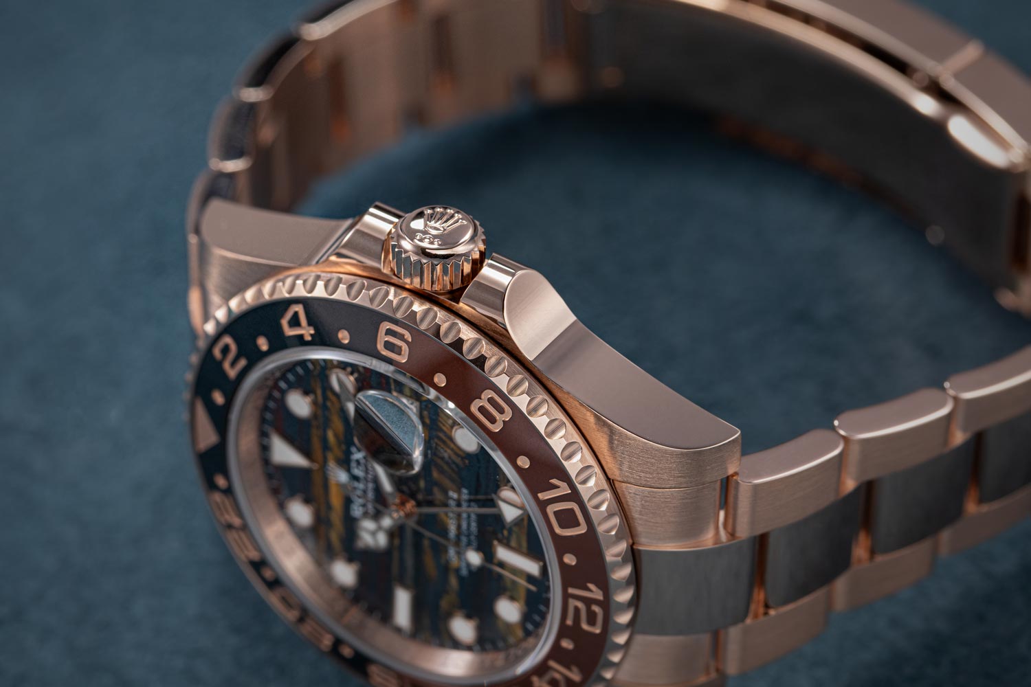 Close-up view of the side profile of the Rolex GMT-Master II, showcasing the crown and case details in rose gold.