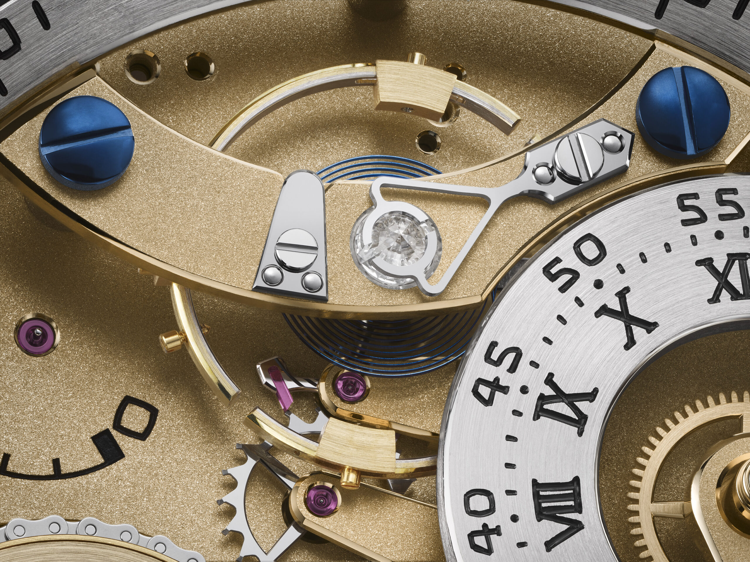 Close-up of the bimetallic Guillaume balance wheel and hairspring inside the Naissance d'une Montre 3
