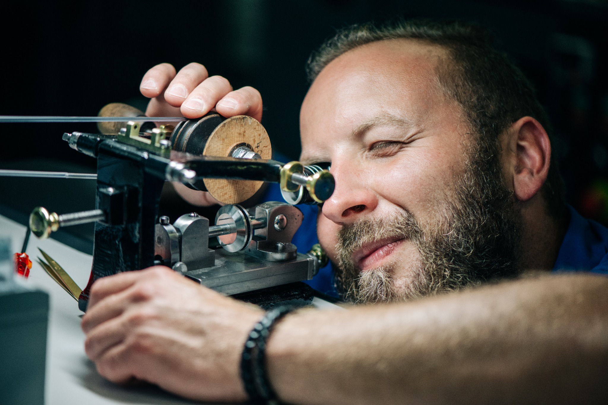Watchmaker using vintage micromechanical tools while assembling parts of the Naissance d'une Montre 3