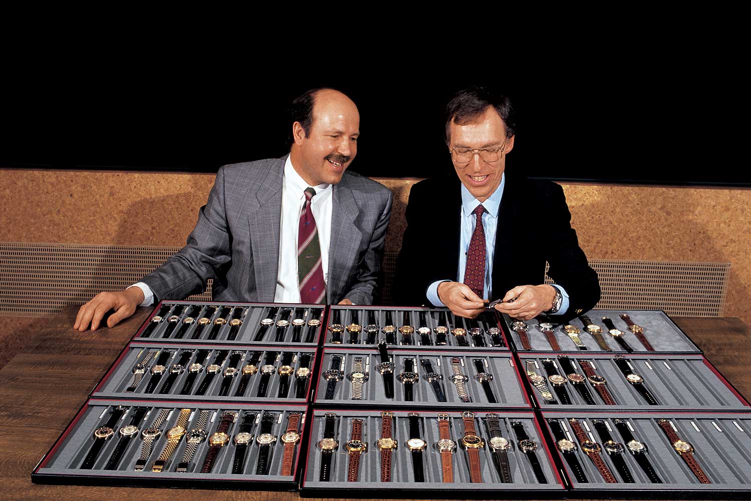 Two men seated at a table displaying multiple watches, representing Oris leadership during its historic transition