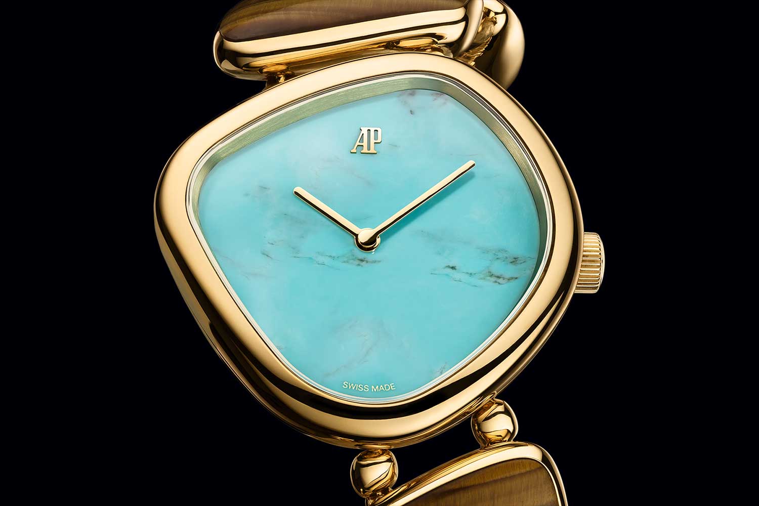 Close-up of Audemars Piguet Galets watch with turquoise stone dial in yellow gold case, minimalist hands and organic pebble-shaped form