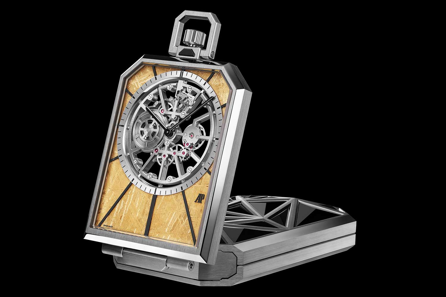 Audemars Piguet Nomade watch in open upright position with skeletonised movement, geometric metal case and textured gold-toned dial elements