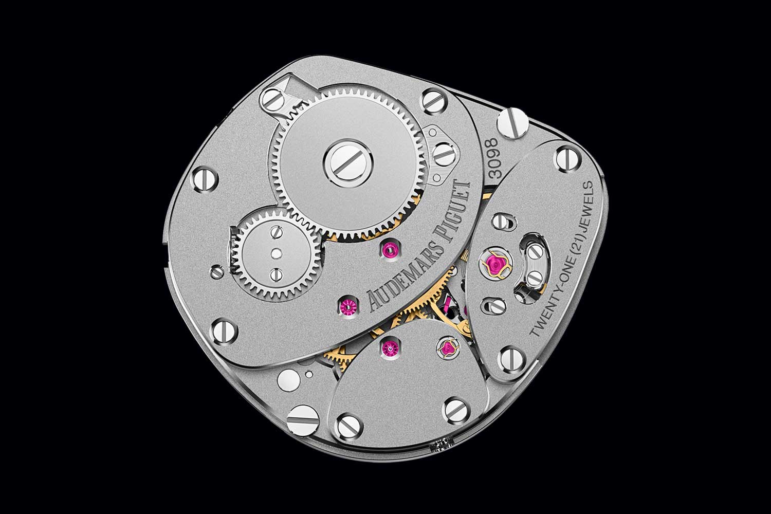 Close-up of Audemars Piguet mechanical movement with gears, bridges and jewels engraved with brand name