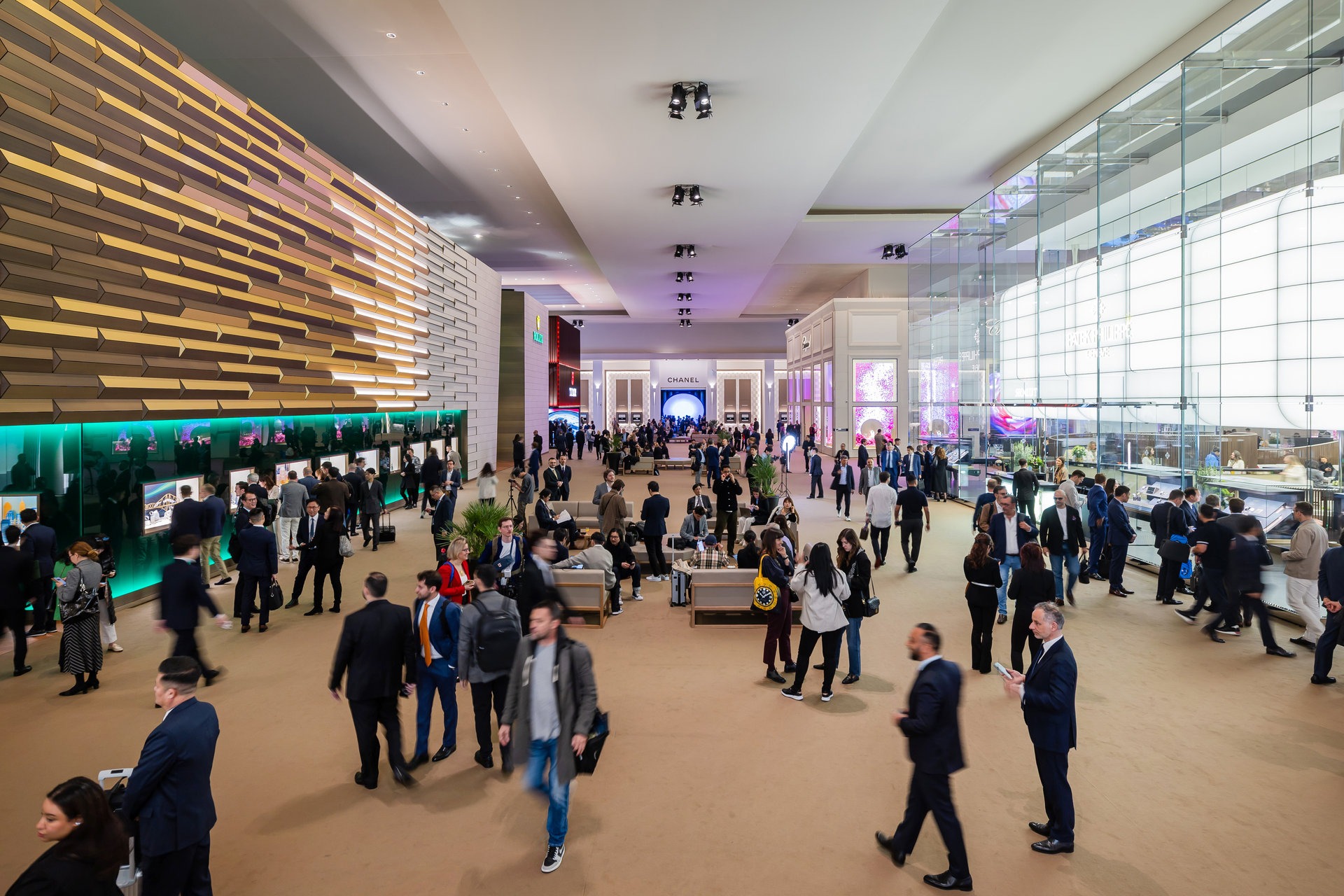 Crowds of visitors inside the Watches and Wonders Geneva exhibition hall, with brand booths and displays across the Palexpo venue