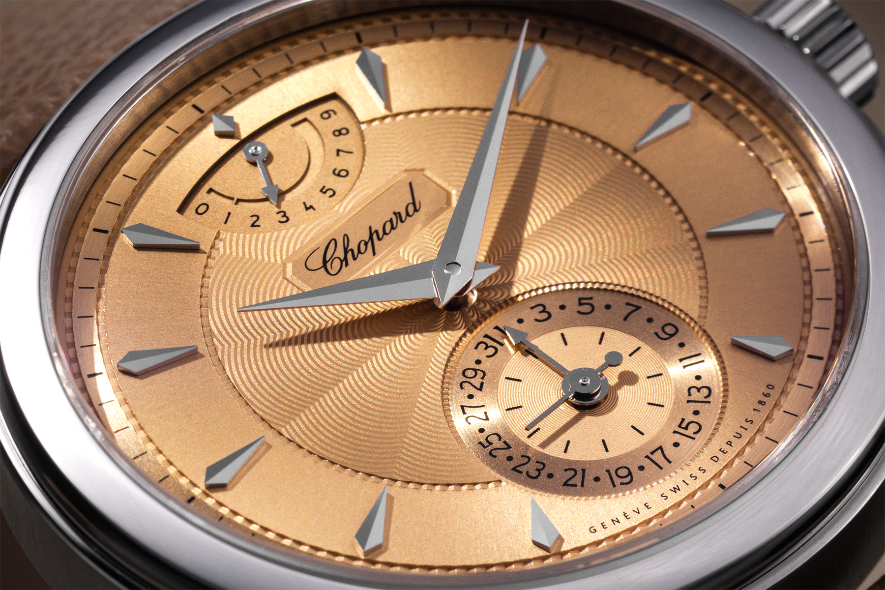 Flat close-up of the Chopard L.U.C Quattro Origin dial showing the hand-guilloché concentric wave pattern, applied kite-shaped hour markers, Chopard signature cartouche, small seconds and date subdial at 6 o'clock, and nine-day power reserve indicator at 12 o'clock
